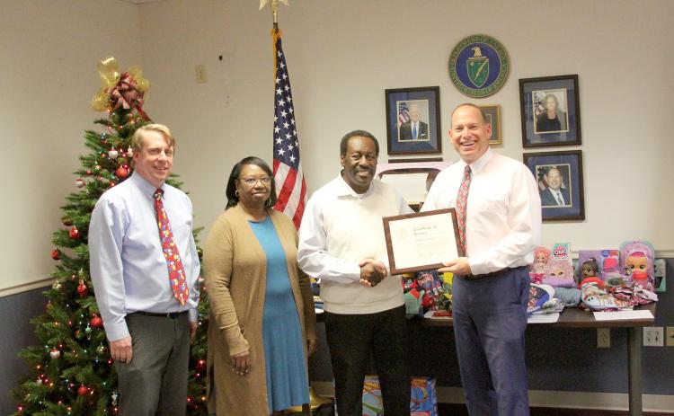 Pictured during a retirement luncheon for Freddie Baker honoring him for his 50 years of federal employment are (L-R) Southeastern Power Administration’s Leon Jourolmon, Baker’s wife Sarah, Baker and SEPA’s Virgil Hobbs. (Photo by Wells)