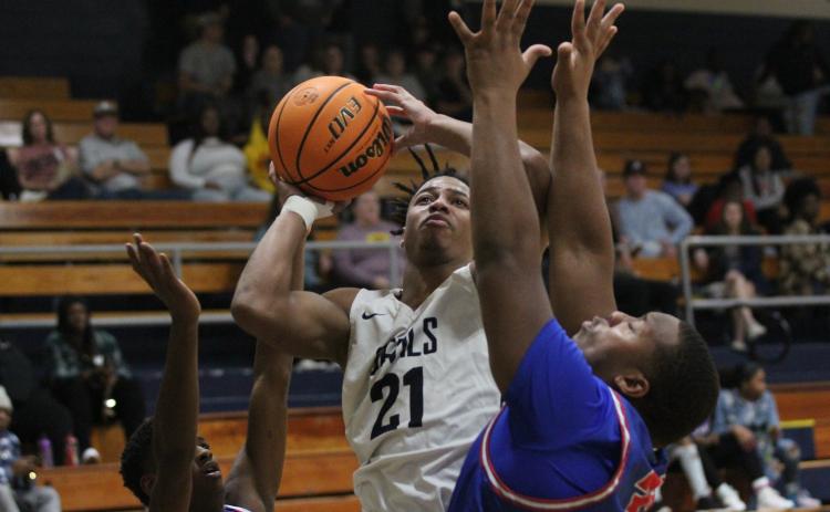 Senior Trustin Allen takes a shot between two Oglethorpe County defenders during the Devils’ 59-46 loss in the Inferno Dec. 17. (Photo by Wells)