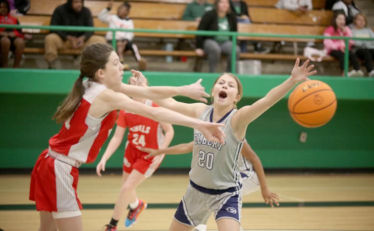 Seventh grade Lady Ram Brylee Dickerson attempts to distract a Stephens County seventh grade Lady Devil during Elbert’s 29-9 smackdown in the first round of the NEGIAA basketball tournament at Franklin County High School Jan. 14. (Photo by Scoggins)