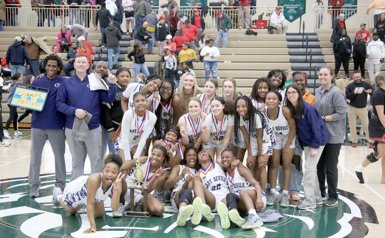 The Elbert County Lady Devils claimed the Region 8A-D1 championship trophy after defeating Rabun County 61-41 in the region tournament Feb. 17 at Piedmont University. The win came nearly one year after the Lady Devils lost the championship to the Lady Cats before ultimately defeating Rabun in the GHSA state championship. (Photo by Scoggins)
