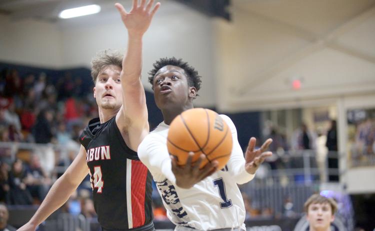 Blue Devil Bob Thomas goes for the goal during the Devils loss to Rabun County Feb. 7. The Devils claimed a spot in the Region 8A tournament and GHSA state playoffs by upsetting Commerce Monday night. (Photo by Wells)