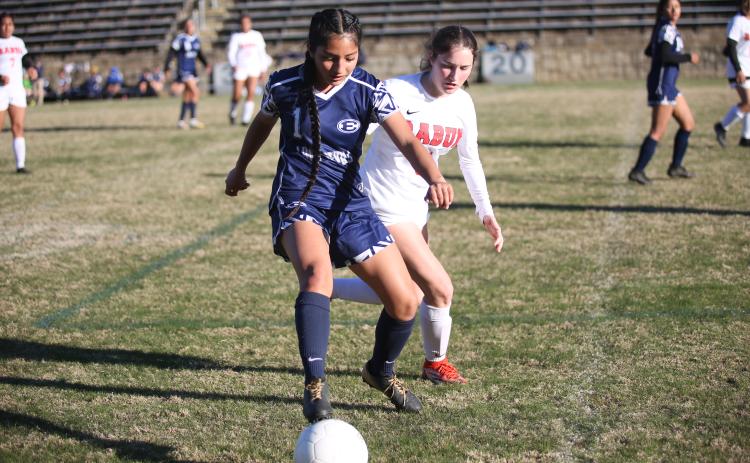 Vivian Salazar covers the ball from a Rabun County defender during the Lady Devils’ region matchup March 14.