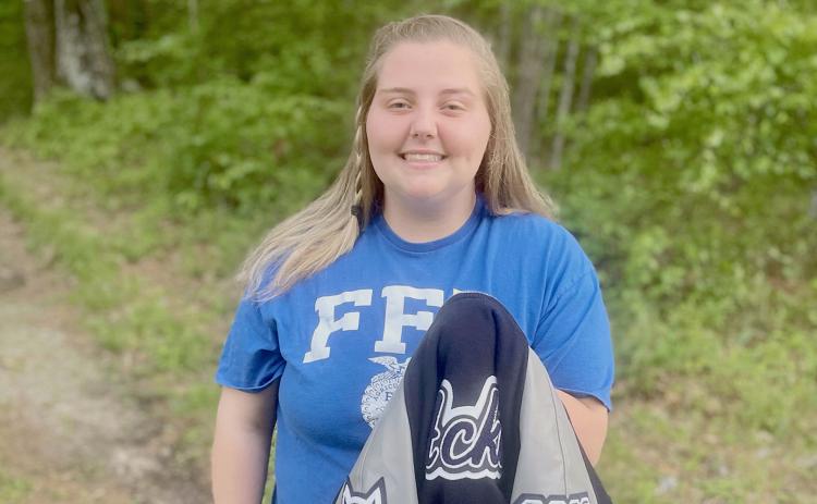ECCHS senior Natalie Acker (left) holds the first letterman jacket obtained by being an FFA Club member.
