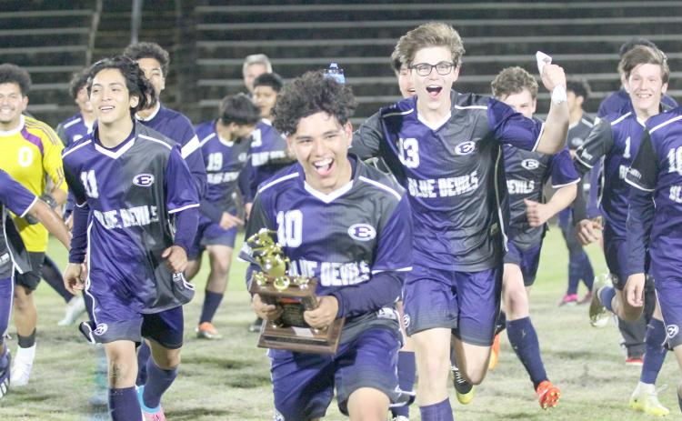 Blue Devils (L-R) Brandon Salazar (No. 11), Chapo Serna (No. 10), Nick Smith (No. 13) and Ian Lavere (No. 1) celebrate the Devils’ win over Barrow March 30 that propelled them to a historic finish as the No. 2 seed in Region 8A-D1. (Photo by Wells)