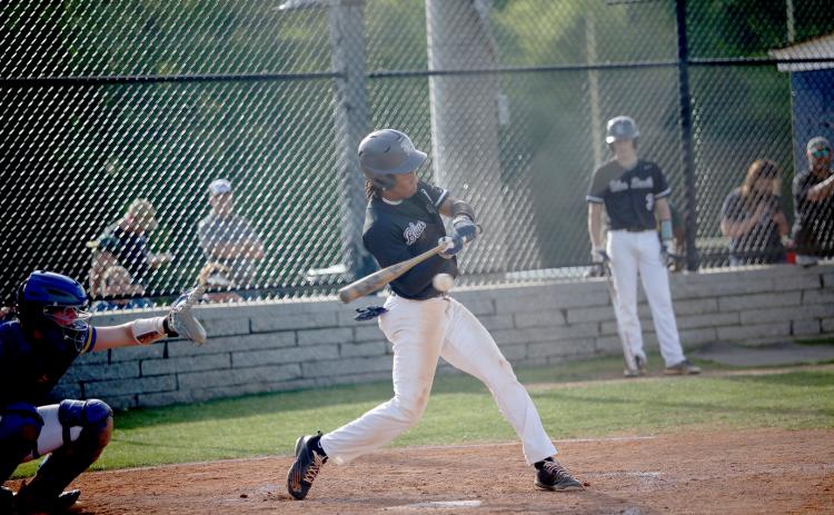 Senior Trustin Allen puts the ball in play during the Diamond Devils’ 14-3 win over Washington Wilkes April 19. (Photo by Wells)