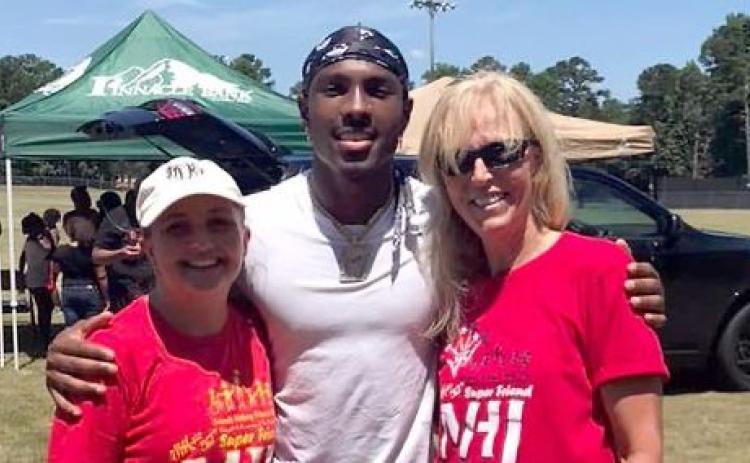 The Friends Helping Friends annual Football Fun Day with Mecole Hardman will take place Saturday, June 17 from 9 a.m. until noon. Pictured during the 2022 event are (L-R) Devon Davis, Hardman and Sandy Adams.