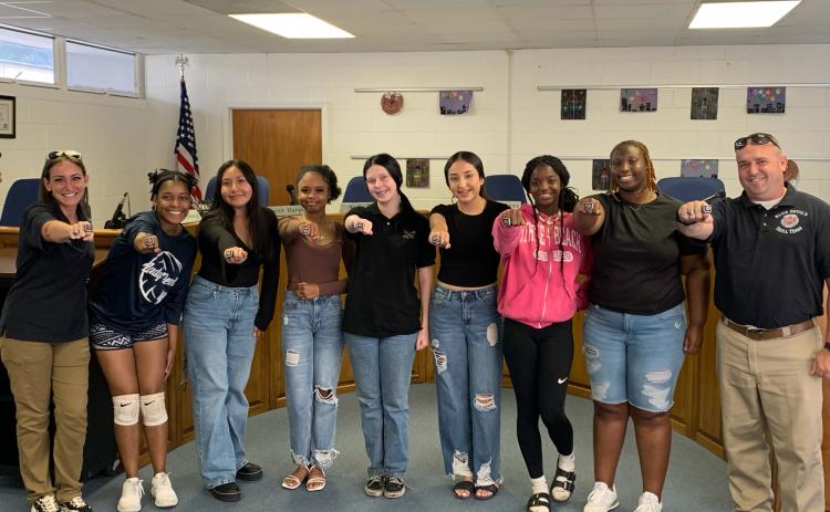 Pictured with their rings are (L-R) Nicole “Drill Mama” Ulrich, Team Leader De’Asia Kinsey, Natasha DeLeon, Chrisiya Harris, Jaelyn Massey, Jolette Medina-Galvan, Ke’miyah Teasley, Co-Captain Nakira Baker and Sgt. 1st Class Daniel Ulrich. Not pictured are Team Captain Lucas Vang and Kaleigha Montgomery. (Photo by Wells)