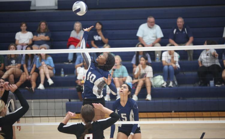 America Vargas (No. 5) watches as Keitasia Glaze (No. 10) leaps to spike a ball in Elbert County’s 2-0 loss to Rabun Aug. 17. The Volley Devils are 3-7 so far on the season with wins over Monsignor Donovan, Washington-Wilkes and Cedar Shoals. (Photo by Wells)