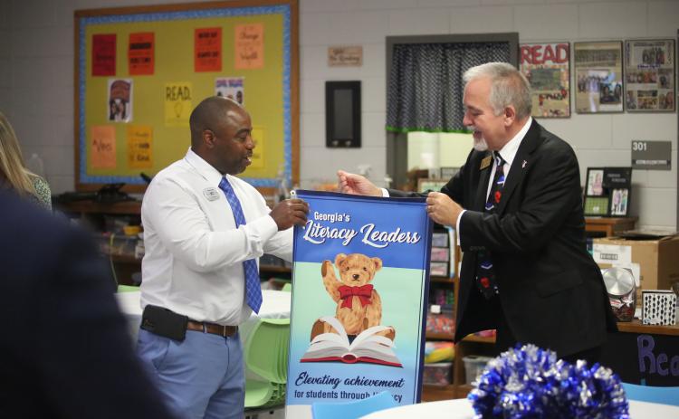 State School Superintendent Richard Woods (right) presents Elbert County Elementary School Principal Jasper Huff with a banner celebrating the school being named one of the state’s Literacy Leaders. (Photo by Wells)