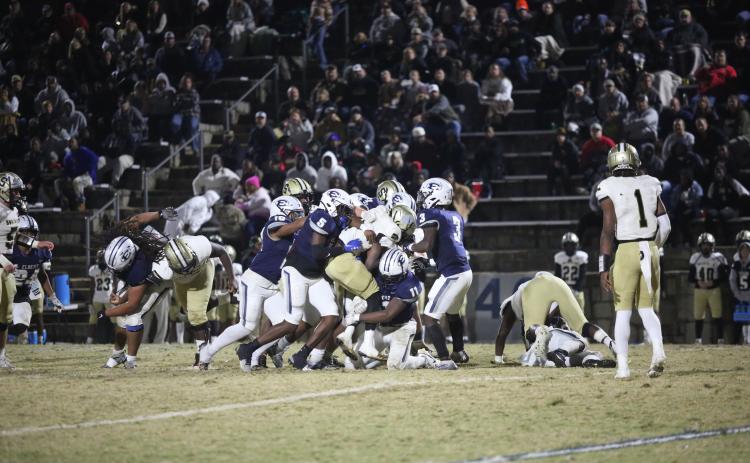 A host of Devils tackle a Swainsboro player during Elbert’s 34-28 loss to the Tigers Nov. 24. The loss brings Elbert’s season to a close after the Devils reached the 10-win mark for the second consecutive season. (Photo by Wells)