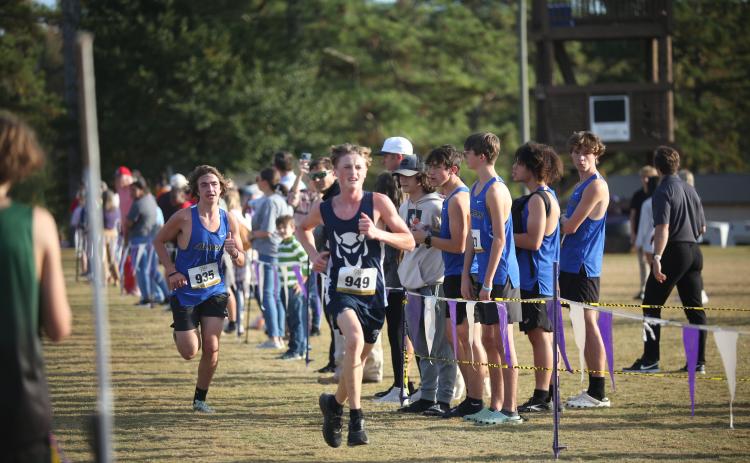 Ezra Adamson beats a Barrow runner to the finish line during the Region 8A Division 1 championship meet Oct. 26. (Photo by Wells)