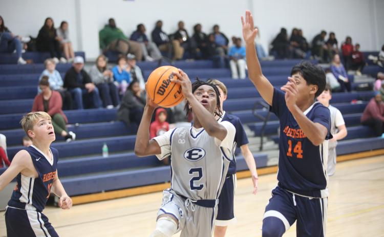 Tyler Turman splits a pair of Habersham defenders and drives to the basket Dec. 11. (Photo by Wells)
