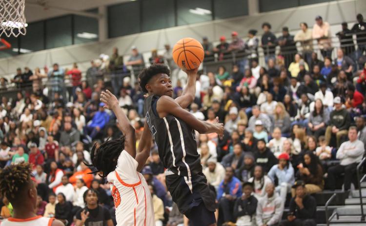 D.K. Winn floats in the air as he attempts a reverse layup in Elbert’s loss to Hart County. (Photo by Wells)