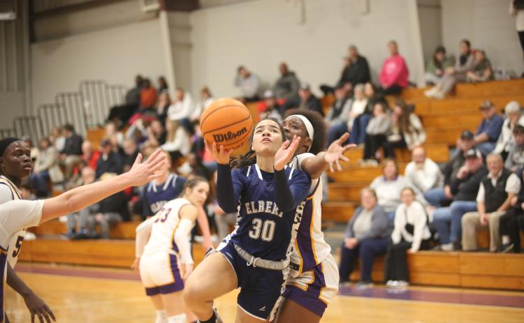 Miya Hood lays the ball into the basket after getting by an Athens Christian defender. (Photo by Wells)