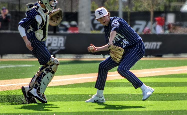 No. 26 Landon Adams gathers the ball and throws to first as Camden Bryant looks on during the GA Dugout Club Tournament. (Photo courtesy of April Dixon Hughes)