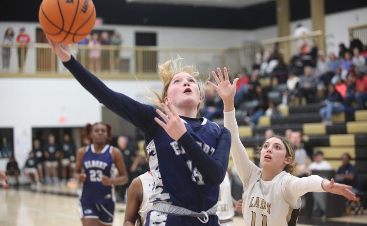 Audrey Lunsford gets by a Commerce defender and lays in an acrobatic layup during the Lady Devils loss to Commerce Feb. 2. (Photo by Wells)