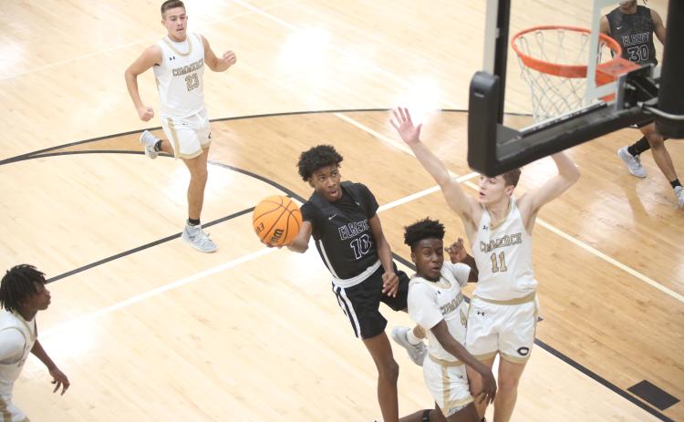 A.J. Brown takes on two defenders and lays the ball in at the end of a fast break during Elbert County’s 59-55 win over Commerce Feb. 2. Brown led the team in scoring with 14 points. (Photo by Wells)