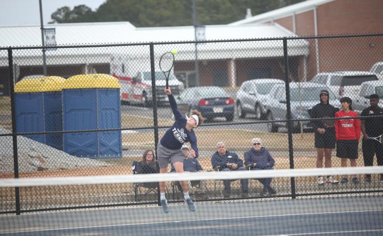 Ty Johnson serves the ball during Elbert’s first home match of the season against Clarke Central Feb. 8. (Photo by Wells)
