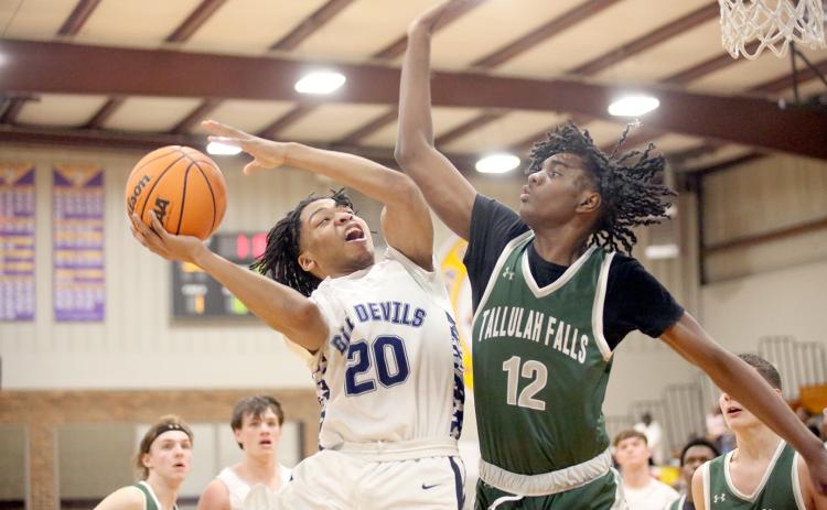Landon Hill goes up with the ball in front of a Tallulah Falls defender during Elbert’s win over the Indians in the Region 8A Division 1 tournament. The Devils finished in third place during the tournament behind a team-high 20 points from Hill. (Photo by Wells)