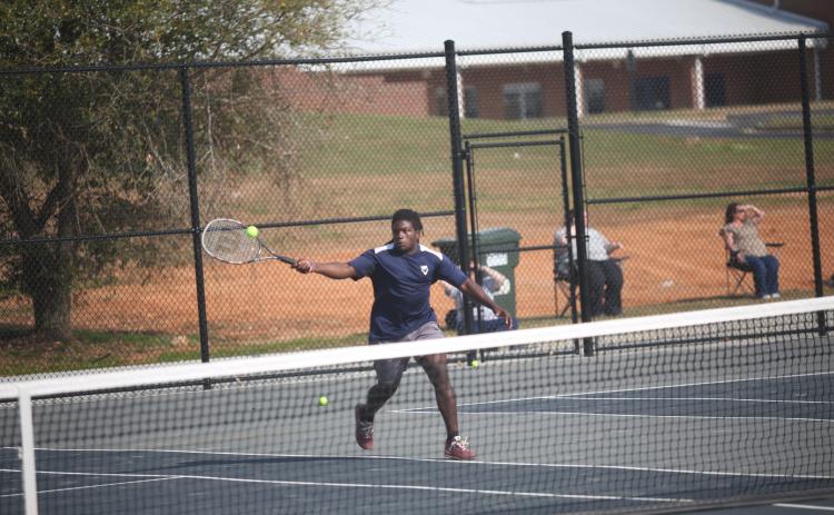 Jasean Jenkins charges the net during his win in the boys No. 1 doubles match against Hart. (Photo by Wells)