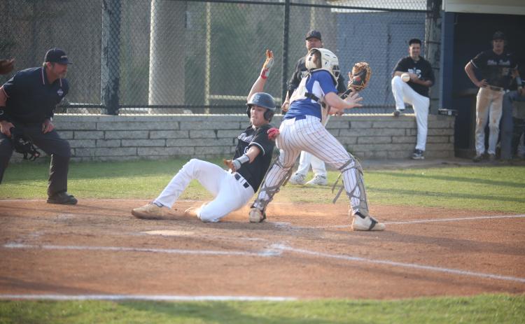 Brooks Banks slides past the Oglethorpe catcher and reaches for the plate as he scores a run for the Diamond Devils in their 10-0 win over the Patriots March 21. Banks finished the game with a home run, two hits, two runs and two RBIs. (Photo by Wells)
