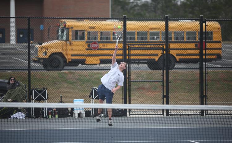 Adrian Jenkins serves the ball during his 9-7 win over his Hart County opponent in the No. 1 singles match. (Photo by Wells)