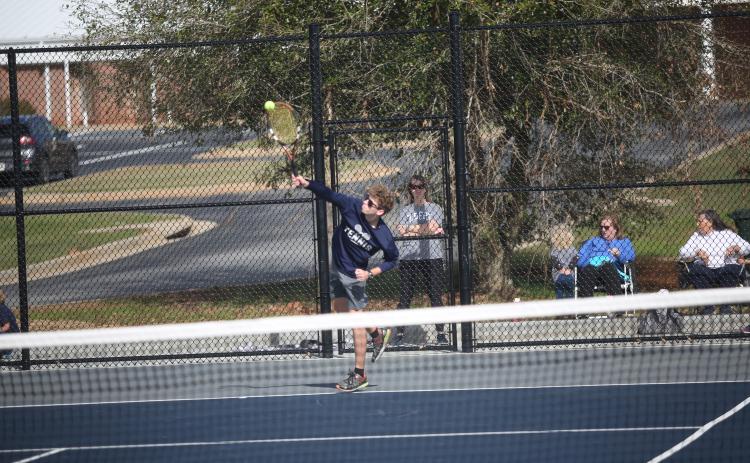 Mitchell Wheeler serves the ball during the Devils 3-2 win over Barrow Arts and Sciences Academy March 11. (Photo by Wells)