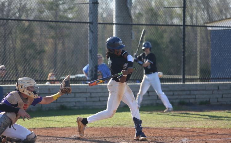 Cheyvis McLendon makes contact with the ball during Elbert’s first game against Athens Christian March 29. (Photo by Scoggins))
