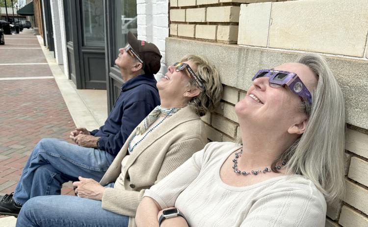 Members of The Elberton Star staff (right, L-R) Earl Saxon, Valerie Evans and Barbara Slay enjoyed viewing the eclipse (left) with safety glasses. (Photo by Scoggins)