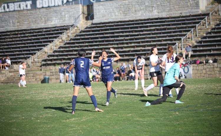 No. 1 Vivian Salazar celebrates with No. 2 Allison Medina after scoring a goal during Elbert’s win over Athens Christian. (Photo by Wells)