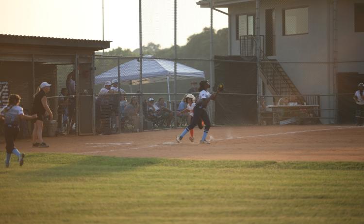 Sameria McClendon catches the ball while tagging first base to put out a runner during the 8-10-year-old Softball District 7 Championship Game against Hart June 27.  (Photo by Wells)