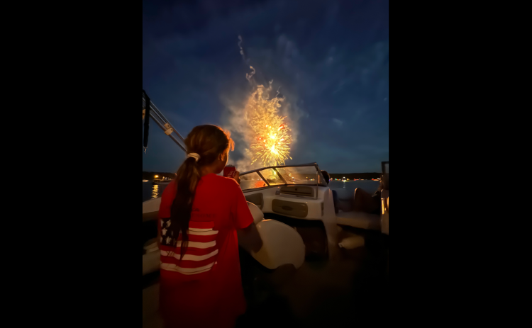 McKenzi Kesler watches the sky light up during the Soap Creek fireworks display while her dad, Larry, captures her reaction on his.