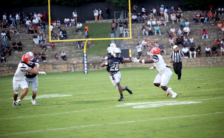 Jacari Barnett throws out a stiff arm towards a Hart County defender during Elbert’s 17-7 loss to the Bulldogs Aug. 16.  (Photo by Wells)