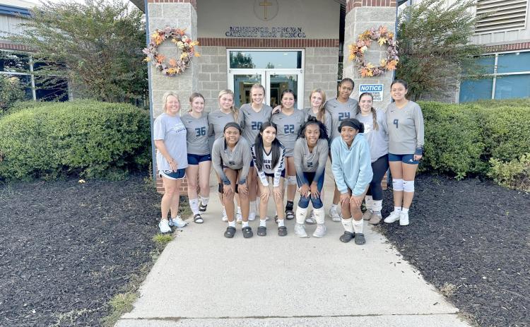 The Lady Devils volleyball team poses for a team picture outside Monsignor Donovan’s gym after winning a pair of games over the Lady Rams and George Walton Academy Sept. 19. (Photo by Wells)