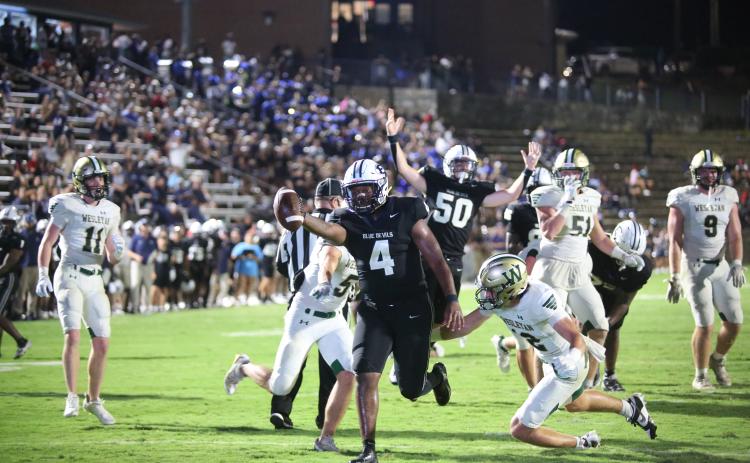 No. 4 Jayvyn Hickman extends the ball over the goal line for an Elbert touchdown late in the fourth quarter while No. 50 Landon Williams celebrates. (Photo by Wells)