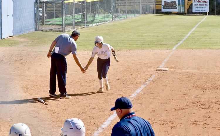 Kamryn Webb high fives Head Coach Bryce Bowen after hitting a three-run home run in Elbert’s second game against Dodge County Oct. 19. (Photo courtesy of Elbert County True Blue)