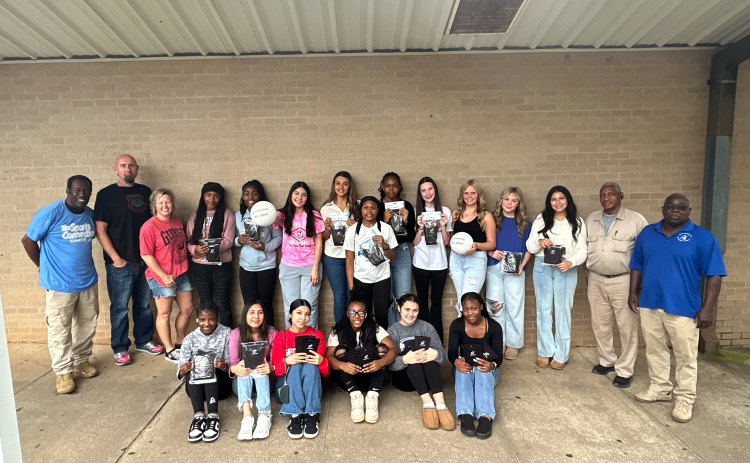 Pictured with some of the donated equipment are (front row, L-R) De’Shayla Jackson, Jessica Flores, Lindsay Castro, Trania Skelton, Amelia Phillips and Aerial Oglesby and (back row, L-R) Freddie Baker, Assistant Coach Shaun Human, Head Coach Anya Human, Anaja Banks, Shamya Davis, Dayana Mota, Melanie Badillo, Lakeria Bradley, Shania Huff, Peyton Roach, Cadence Noggle, Kendall Baston, Zurina Dillard, James Jordan and Alfred Dye. (Photo by Wells)