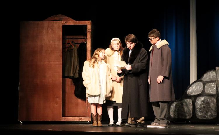 Lucy (Lyla Kate Johnson), Susan (Adrianna Pennington), Peter (Jake Triplett) and Edmund (Parker Jenkins) examine some mysterious instructions after entering Narnia via the wardrobe. (Photo by Weeks)
