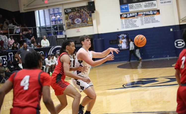 Haven Adams swings the ball around the top of the key during Elbert’s loss to Madison County Dec. 7. (Photo by Wells)