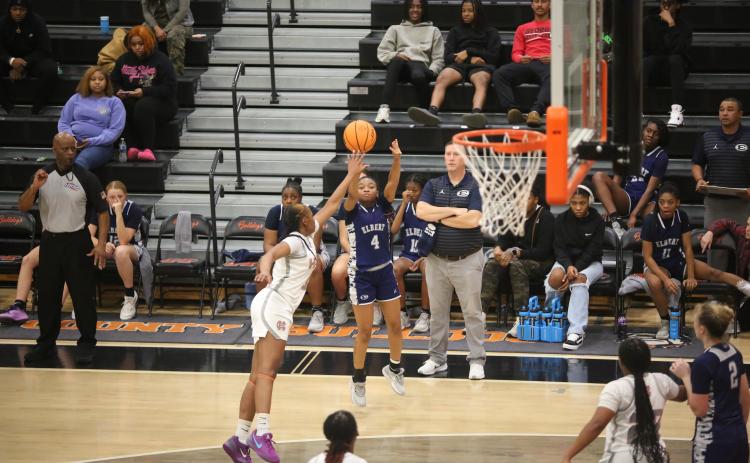 Kaylen Rucker puts up a three pointer while Head Coach Josh Jones looks on. (Photo by Wells)