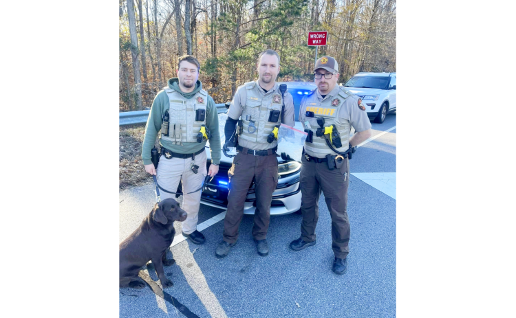 (L-R) K-9 handler Cpl. Jonathan Dove of the patrol division (with drug dog Baretta) and Lt. Clete Brady and Lt. Allen Frady of the Drug Investigations Unit display methamphetamine collected Dec. 12. (Photo submitted by Elbert County Sheriff's Office)