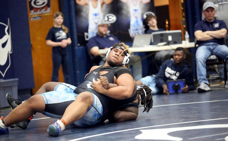 Senior M.J. Cook maneuvers around his opponent while fighting for leverage during the Inferno Invitational hosted by the Mat Devils in the Inferno Jan. 25. (Photo by Wells)