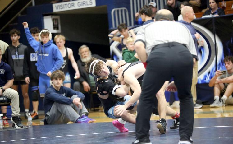 Cruz Floyd pulls his opponent to the mat with the help of a headlock during the area traditional championships. (Photo by Wells)