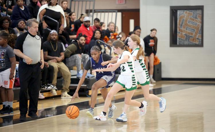 Lisa Hill dribbles past a Franklin County double team during the NEGIAA seventh-grade region championships hosted by Hart County Feb. 1. Hill led the Lady Rams in scoring with 16 points. (Photo by Wells)