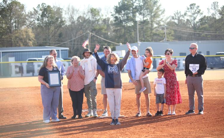Kim Harper Bray (center) waves to the crowd during her jersey-retirement ceremony in between the Lady Devils softball team's doubleheader against Johnson March 12. (Photo by Wells)