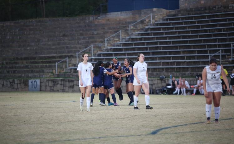 The Lady Devils swarm Victoria Medellin after she scored the game-winning goal in the second-half of extra time to beat Commerce 3-2 March 14. (Photo by Wells)