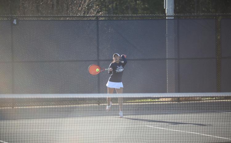 Emily Poon returns a serve during her win in the No. 1 singles match against Washington-Wilkes March 6. (Photo by Wells)