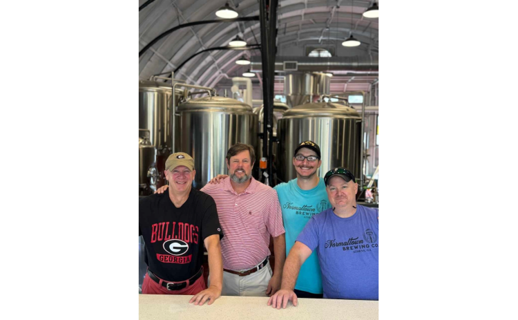 Normaltown Brewing’s majoroity owners Scott Fortson,  David Abernathy, Erich Fietkau and Phil Fortson stand in front of the tanks in the facility on Barber Street in Athens. (Photo submitted by Scott Fortson)