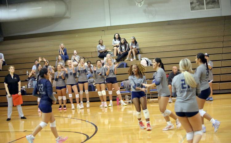 Trania Skelton (2) and Alexia Vargas (far right) celebrate after a point in Elbert’s match against Rabun County on September 3. (Photo by Bo Underwood)