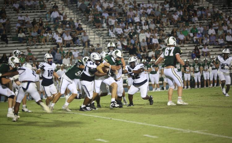 A host of Devils wrap up a Wesleyan ballcarrier during Elbert’s 14-7 loss Aug. 29. (Photo by Bo Underwood)